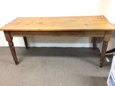 A late 19th century pine kitchen table the rectangle planked top on turned legs length 182cm. X75cm