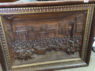 A Carved three dimensional plaque depicting a 17th century scene with numerous figures in a Court interior. 93x72cm