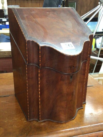 A George III mahogany cutlery box with a shaped front enclosing a later fitted Stationary interior.