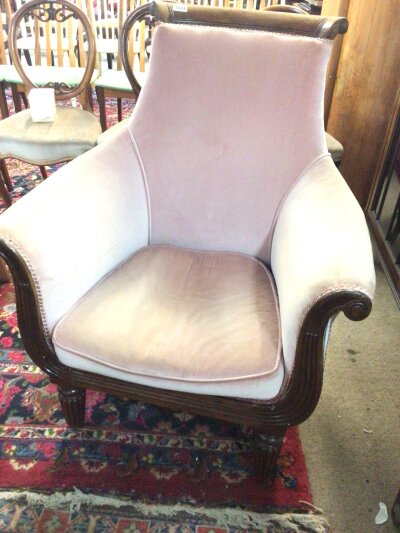 A William VI arm chair with scroll ends and carved show wood top rail on fluted legs