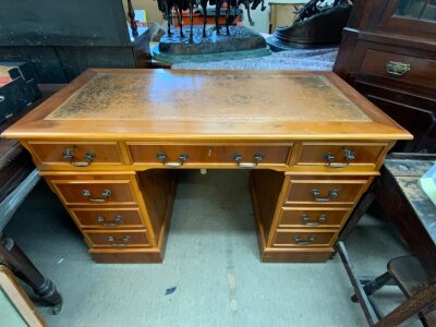 A yew wood veneered small pedastal desk. 121cm x 60cm x 79cm