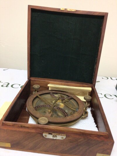 A retrospective copy Dollonds Portable Sun dial in a walnut brass bound case.