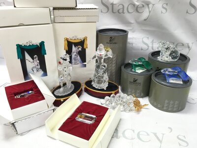 A Collection of boxed Swarovski crystal glass figures including Masquerade Columbine and Harlequin with stands and plaques, fishes, bear and grapes.