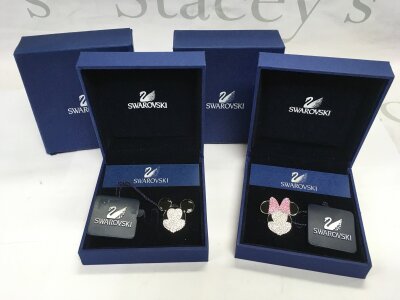 A boxed pair of Swarovski Mickey & Minnie Mouse brooches (2).