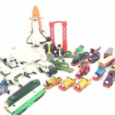 A Box Containing a Collection of Ertl Thomas the Tank Engine Trains and Tonka NASA toys.