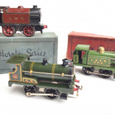 A Box Containing 0 Gauge Locos. Track and Wagons.