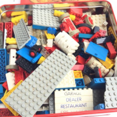 A Tin Containing a Collection Of Loose Vintage Lego.