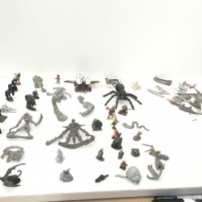 A collection in excess of 50 pieces of metal figures and accessories from Warhammer. Mostly unpainted.