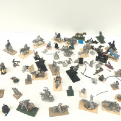 A box of metal models from a warhammer collection mostly horses with riders. A mixture of both painted and unpainted