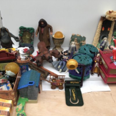 A large collection of of Harry Potter merchandise including wands..action figures..games..electronic games..etc.