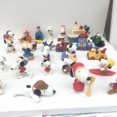 A collection of 25 Collectable Snoopy characters varying in age.