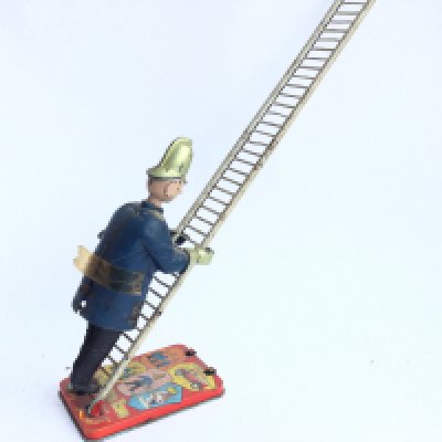 A Marx Toys Tinplate Wind Up Trumpton Town Fire Brigade. Fireman Climbing Up A Ladder.
