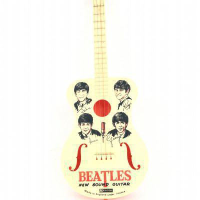 A 1963 Selcol Beatles Child Guitar With Plectrum.