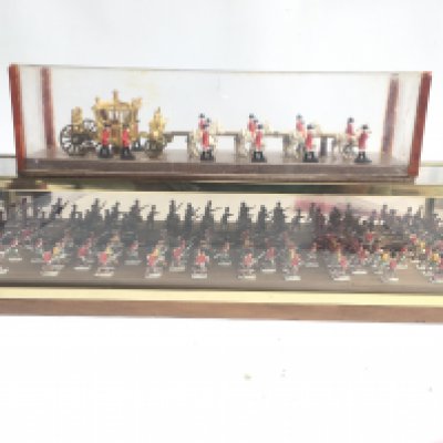 2 Display Cases Containing painted Led Soldiers and The Royal Coach. Approx Length 61 Cm.