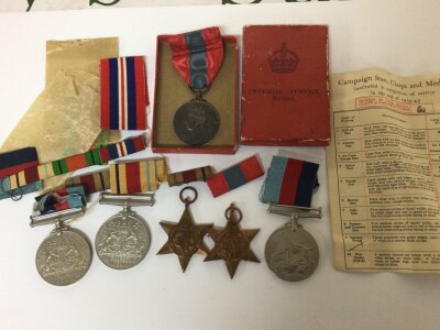 A Collection of II world war medals recipient unknown Two Defence Medals Victory medal Atlantic star 39-45 star and a boxed Imperial Service Medal. With ribbons.