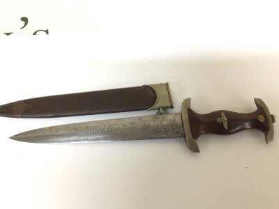 A German Third Reich Genuine SA presentation dagger the walnut grip with red SA symbol inset engraved blade with makers mark and with scabbard.
