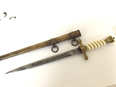 A German Third Reich II world war Kriegsmarine Presentation officers dagger with brass eagle pommel etched blade. Brass scabbard. Nice original condition. .