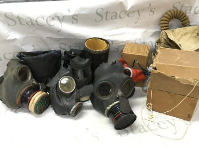 A collection of gas masks including a Third Reich children's mask, British civilian duty respirator, Mickey mouse children's gas mask, boxed examples