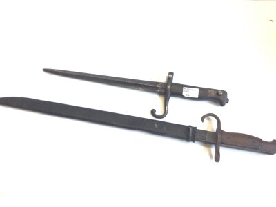 A Japanese II world war Arisaka bayonet. The blade marked with three entwined circles hook quilon wood grip and steel scabbard and one other bayonet no scabbard (2)