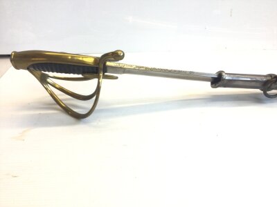 A French Empire AN IV Dragoon sword with an engraved steel blade brass guard and steel scabbed.