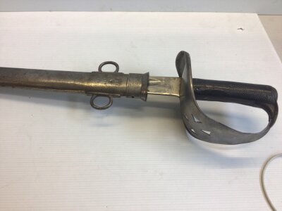 A British Cavalry Troopers sword 1895 pattern with military markings to the blade and scabbard.