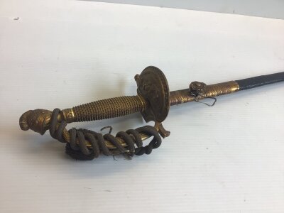 A British Court Sword with Knights head pommel and gilt brass. the engraved blade with maker J Jones Regent street.