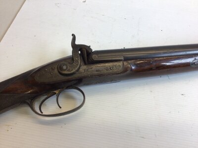 A quality antique muzzle load hammer shot gun percussion. Maker J Beattie 205 Regent St London. Good walnut stock engraved action with a working dog. The action and barrel with makers marks.
