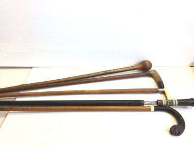 An Indian ebony and bone antique Sword stick four other walking sticks with silver and 9carat gold mounts.
