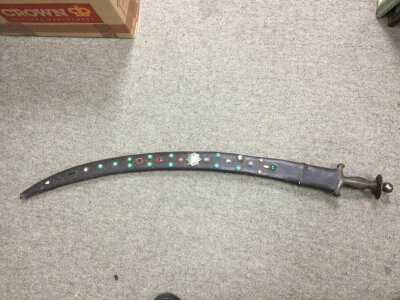 An Arabian Tulwar in a decorated scabbard. 94cm long