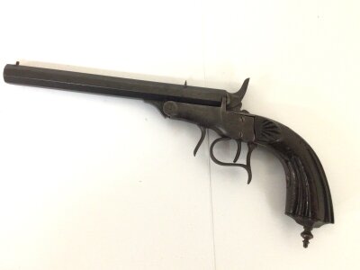 A 19th Century Antique target pistol Belgium E.LG. With a carved walnut grip steel action and trigger guard with some engraving serial number 14946  stamped MA the Octagonal barrel J Leclerco.  length 32cm approximately.
