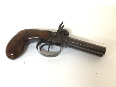 A 19th Century Antique double barrel percussion pistol with a walnut grip. Steel action with double octagonal barrels the trigger guard stamped AV&SG. Length 20cm