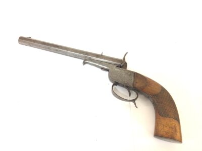 A 19th century Continental target pistol with a carved grip. engraved action and trigger guard. Length 38cm.