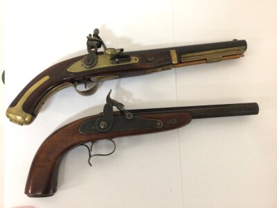 Two Replica Pistols a Flintlock with brass fittings and a Percussion with an octagonal barrel. Non firing ornaments.