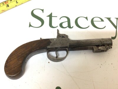 An Early 19th century percussion personal protection pistol with a trigger guard release flick bayonet slab sided mechanism with scroll engraving maker Wallas walnut grip. Length 22cm