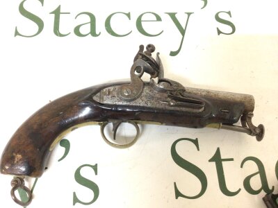 An 18th century flintlock pistol walnut stock brass fittings hinged steel ramrod. Possibly a 16bore Coastguards Pistol the mechanism stamped with Tower proof crown GR. further marks to the stock length 26cm.