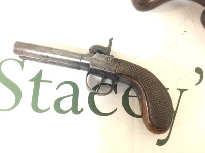 A 19th century double barrel percussion pistol. double hammer and triggers partially engraved steel slab sided action and walnut grip no obvious maker action functions 19cm long.