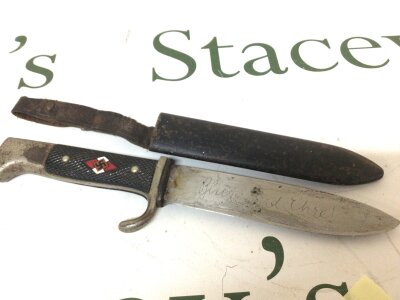 A German Third Reich Hitler Youth Knife maker Justinus with an etched blade the grip with enamel inset good original condition.