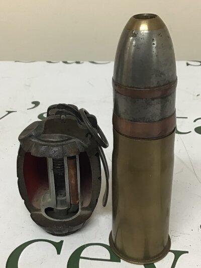 A Section of a hand grenade demonstrating the mechanism and a brass shell case with marks to the base (2)