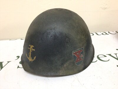 A Combat helmet possibly Italian Navy helmet with Decals on the front and side.leather lining and possibly II world war era.
