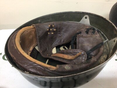 A British Military helmet Black finish with a folded edge original lining and possibly post II World war despatch riders helmet.