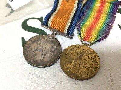 Two I world war medals awarded to 61016 Cpl W.R Noble Lan Fus and an Army Cyclist Corps badge.