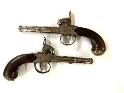 A pair of percussion cap duelling pistols by Bennett, Royal Exchange London, each with hallmarked silver grip ends with marks for Charles Feis & Co, Birmingham, 1779 in the form of a bearded man. Proofing. Marks to both barrels. Small tin of F.Joyce Percussion caps.