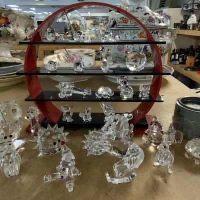 A good collection of Swarovski crystal figures including a Swarovski Perspex stand. (Some figures with damage).