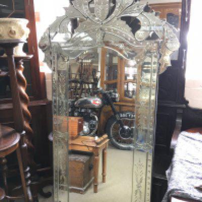 A large Venetian mirror , dimensions 97cm wide 179cm tall