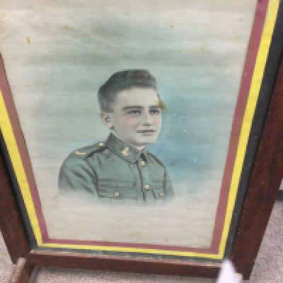 A fire screen inset with a portrait of Walter Sidney Tibrook the Norfolk Regiment.- NO RESERVE