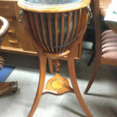 A yew wood jardini̬re stand of Classical style with inlaid stretcher and three splayed legs, approx height 83.5cm. Shipping category D.