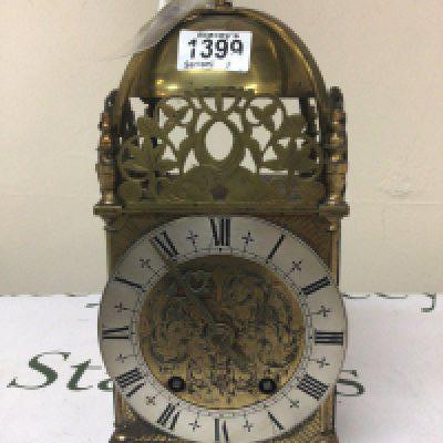 A British brass lantern clock with a silver chapter ring sold with key Height 32cm.