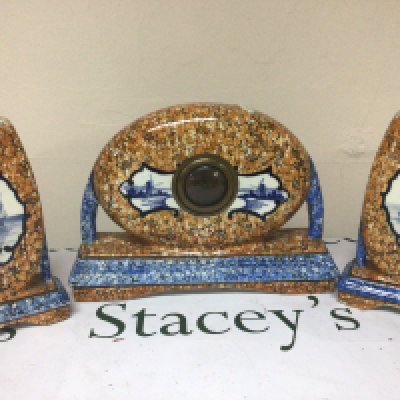 A Dutch ceramic clock garniture of Art Deco design decorated with traditional Delft panels. Height 24cm