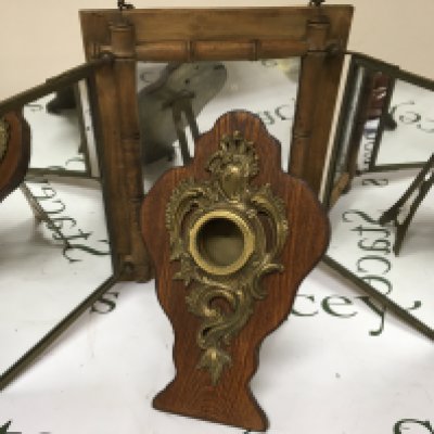 A brass and oak Victorian pocket watch stand Hight 26cm and a simulated bamboo triple mirror frame.