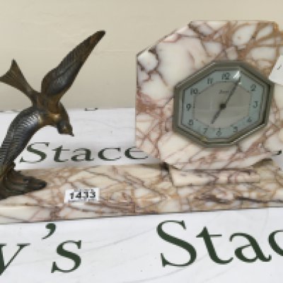 An Art Deco French Marble mantel clock surmounted with a flying bird. Length 41cm
